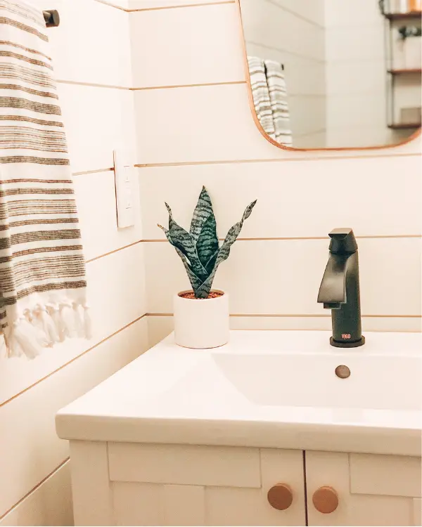 The white shiplap makes the small half bathroom look larger.