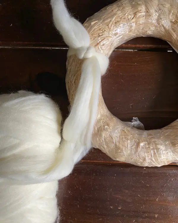 First you tie a knot when making the yarn wreath.