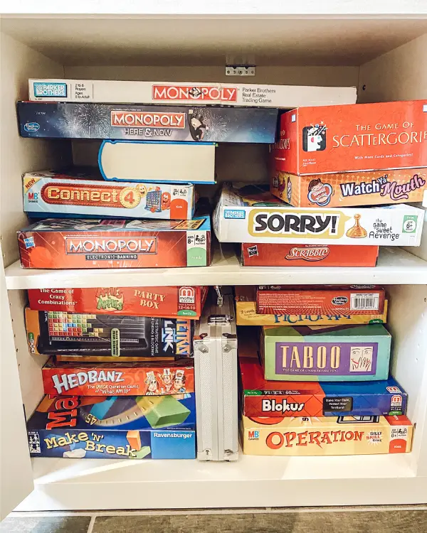 board games fit well inside the cabinet of the entertainment center