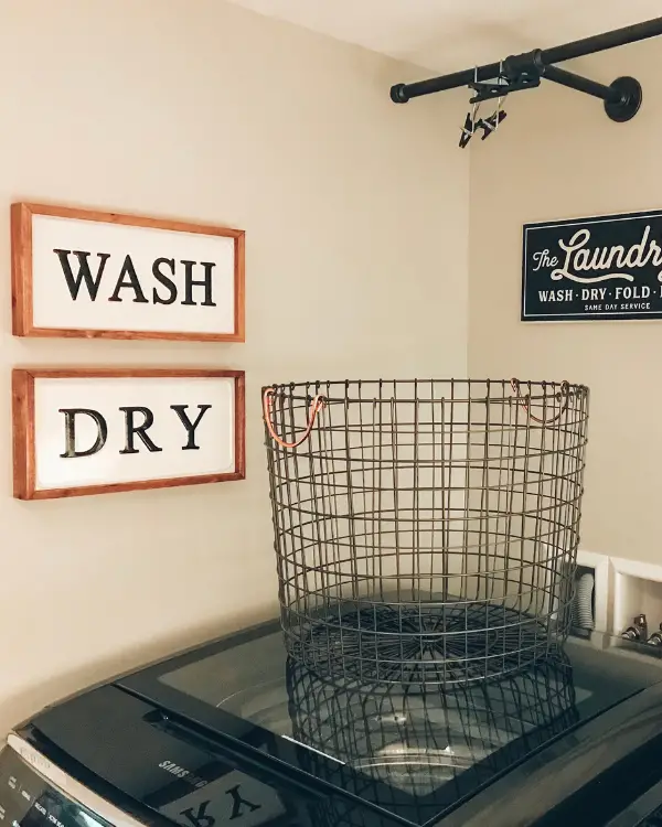 Adding some artwork and decor in a laundry room is a must!