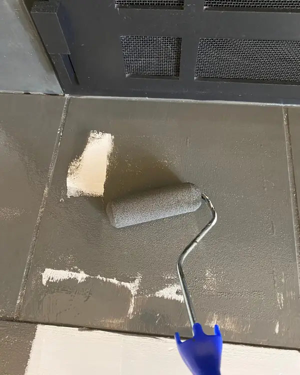painting the tiles with a foam roller