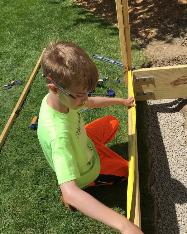 Tyler building the first garden fence when he was younger.