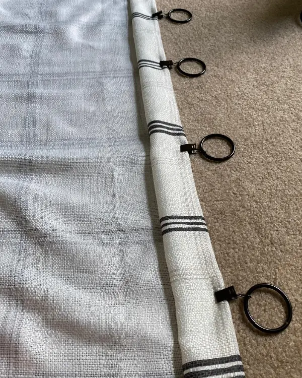 Using curtain rings to hem the curtain without sewing!