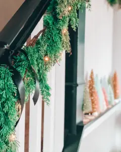 Decorating The Staircase For Christmas With Garland And Bells