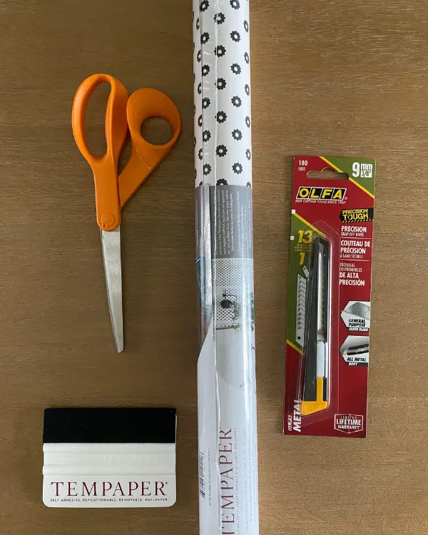 The tools you'll need to wallpaper the china cabinet.