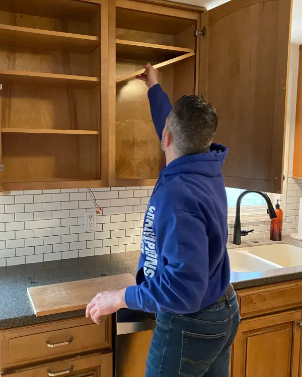 Removing the shelves out of the cabinet first.