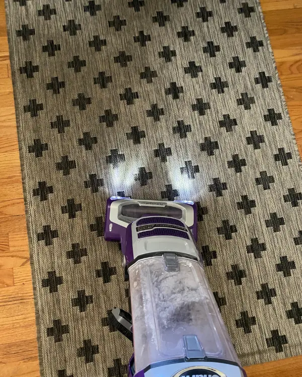 vacuuming the rug