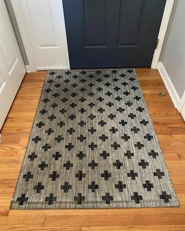a dirty indoor/outdoor rug in the entryway