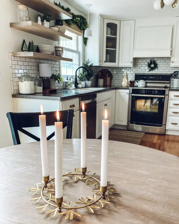 A centerpiece with candles is a simple way to decorate the kitchen for Christmas.