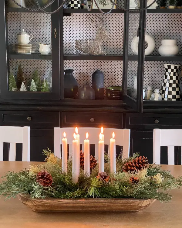 A Christmas centerpiece with lit candles