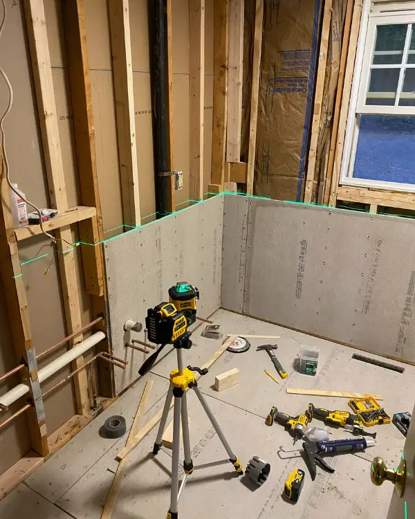 using a laser level to install cement board part way up the wall for tile