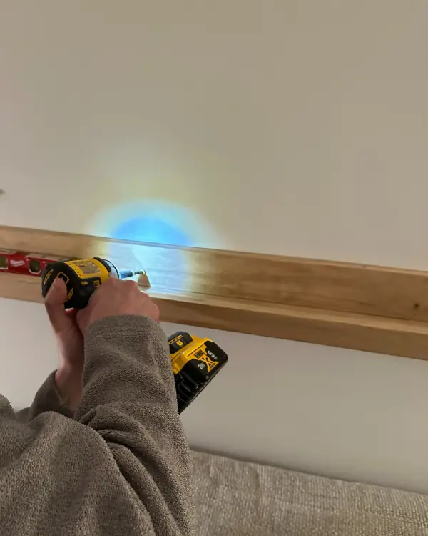 drilling the art ledge into the wall