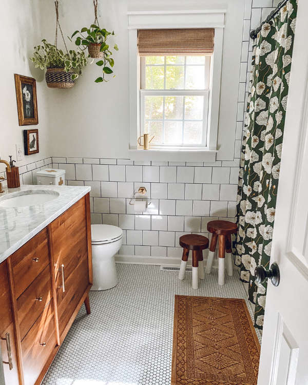 The completed bathroom remodel including the white penny tile floor and a mid century modern vanity.