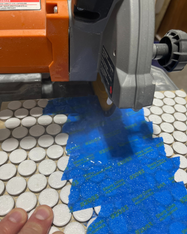 using tape when cutting the tiles is one of the tips for installing penny tile