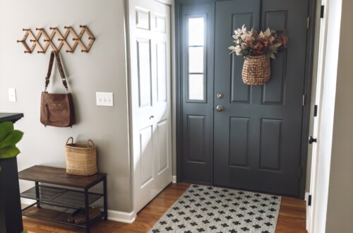 This dark gray front door has the trim painted to match