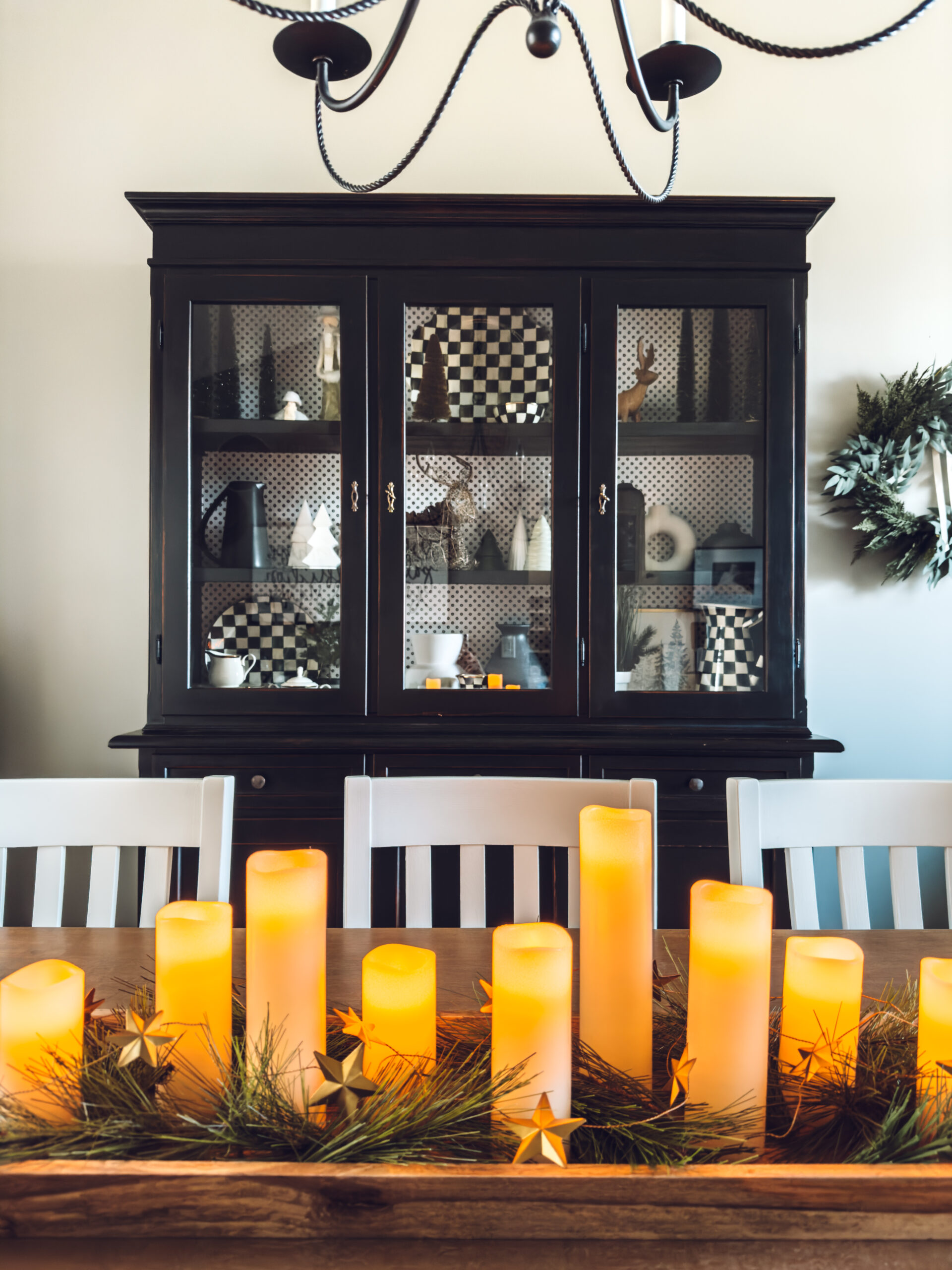 How to style a tray for Christmas? Add flameless candles, greenery and star garland.