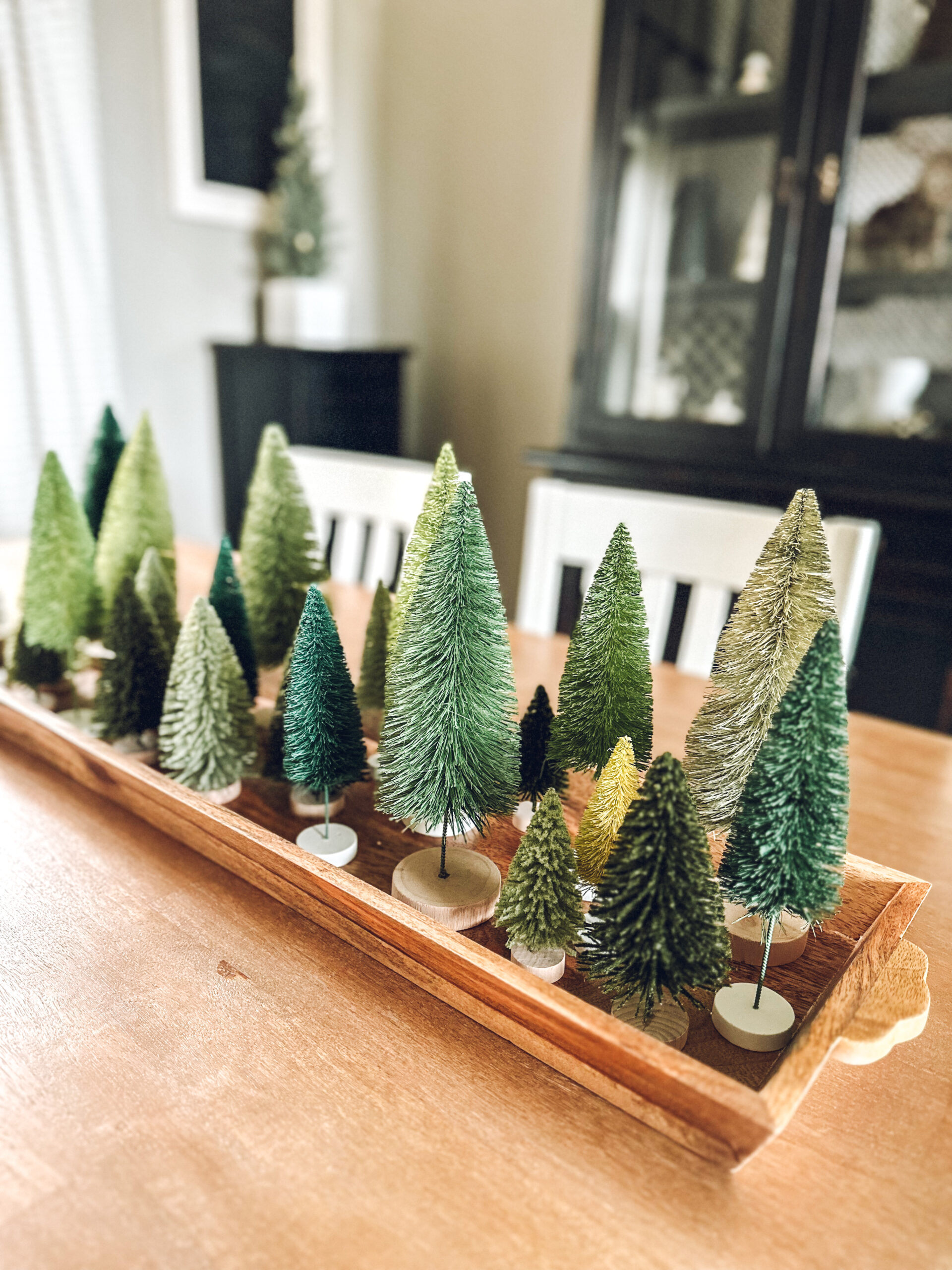 How to style a tray for Christmas? Fill it with bottle brush trees.