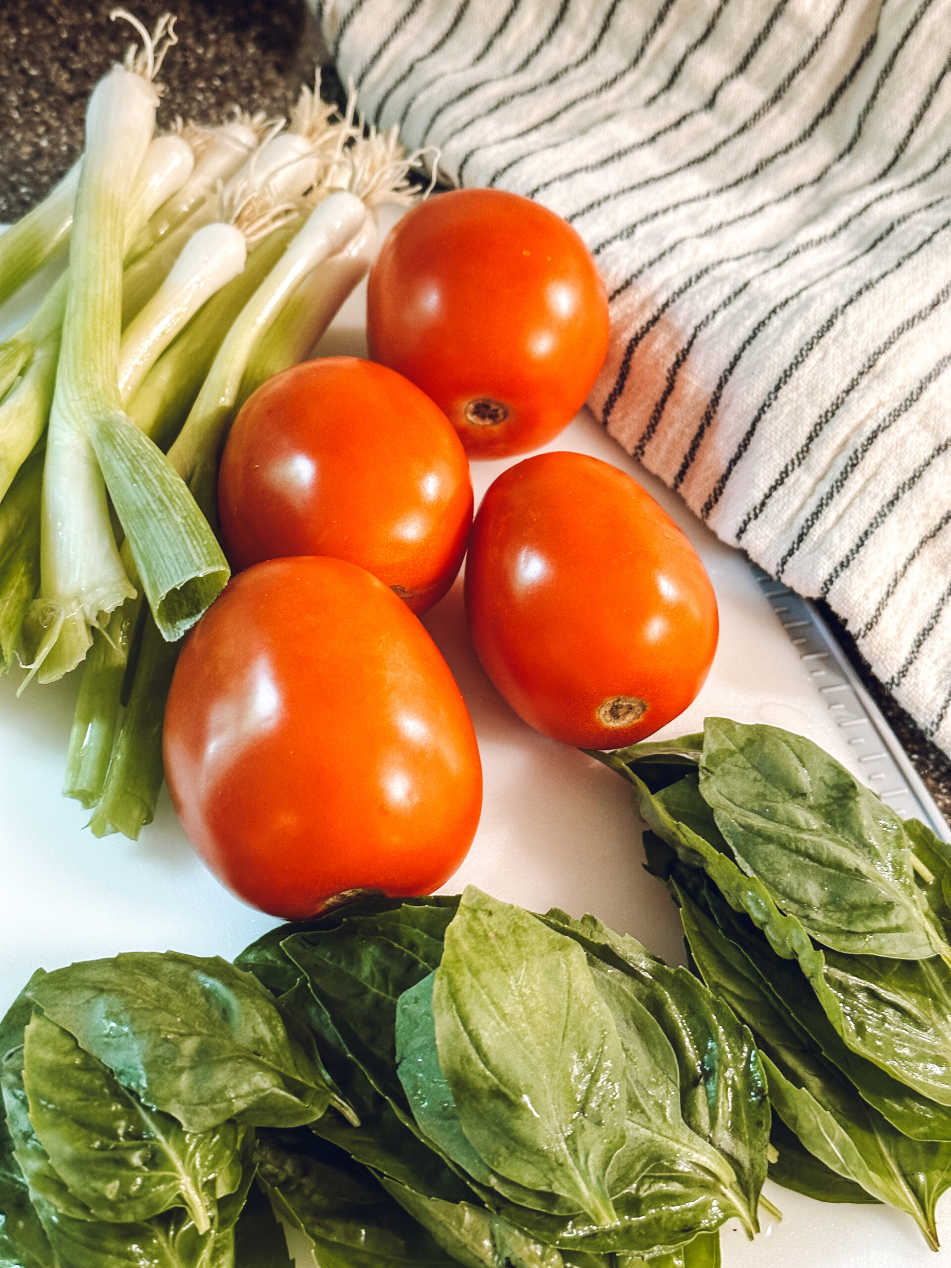 tomatoes, scallions and basil to make couscous salad