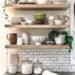 The green Mason Cash bowl on kitchen shelving containing neutral decor adds color to the kitchen