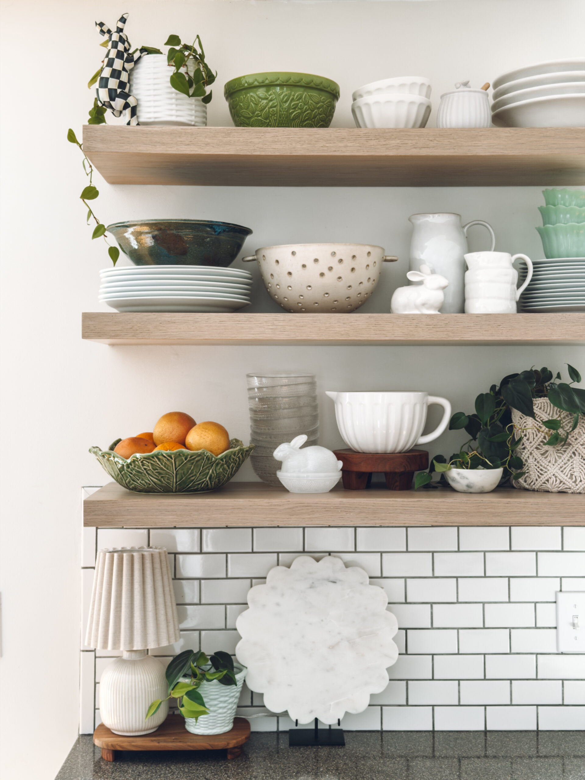 open shelves in the kitchen with touches of spring like bunnies and pops of green