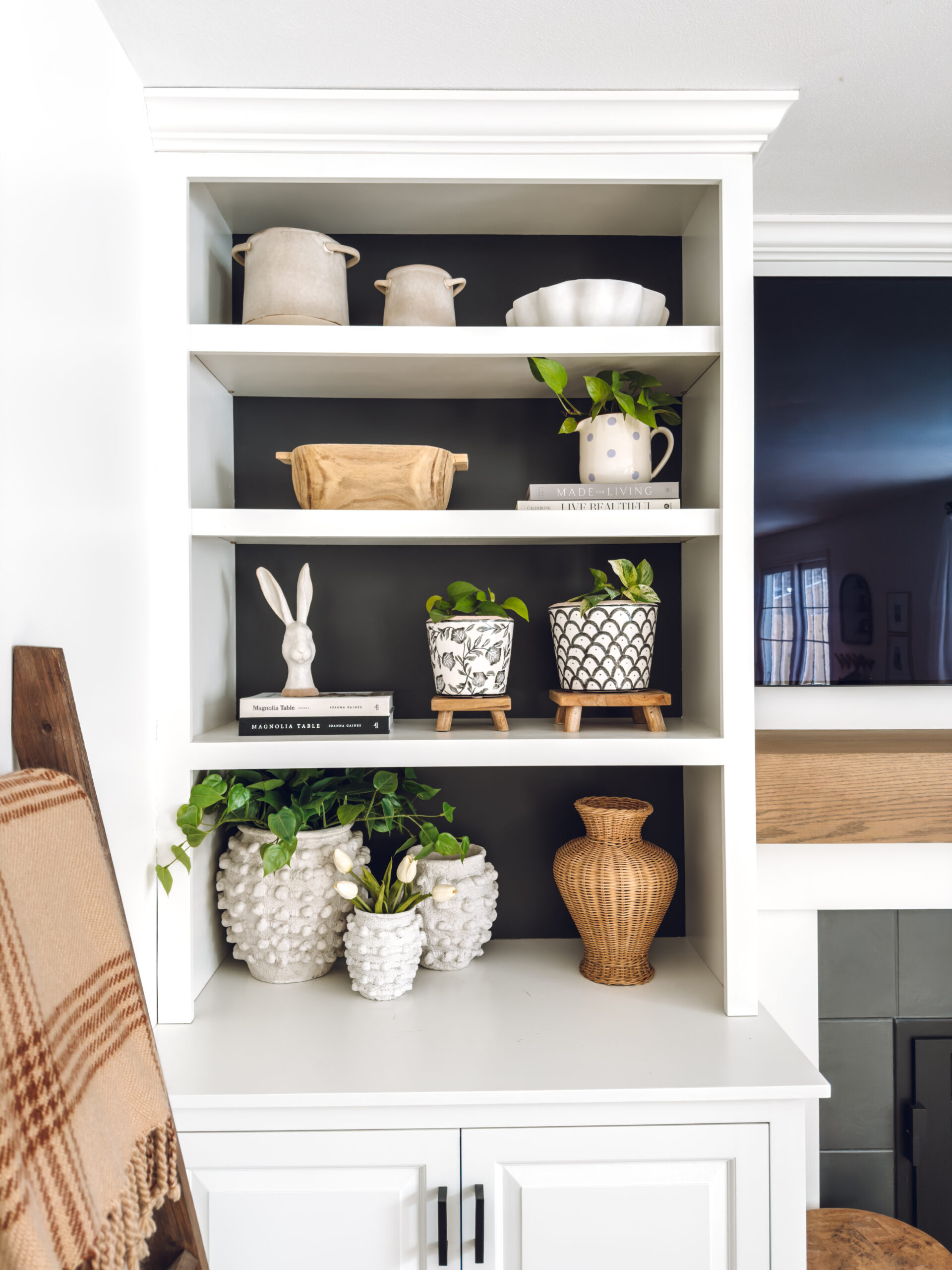 a whimsical bunny bust on the shelf for spring and some white tulips