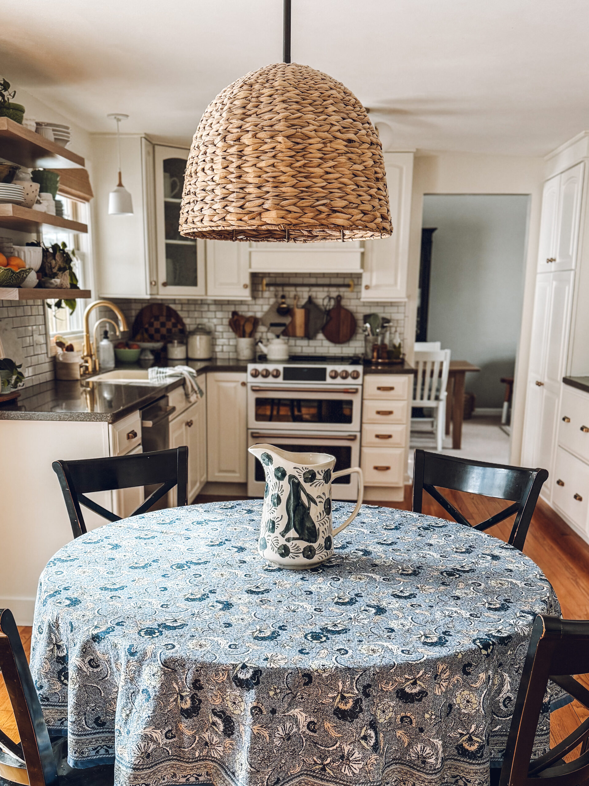 blue and white bunny pitcher on a blue floral tablecloth for spring